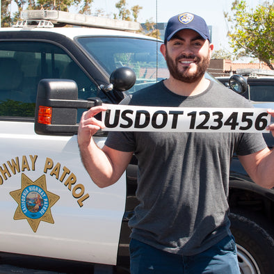 chp officer holding usdot decal sign